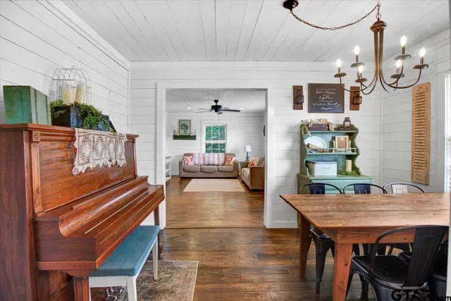 a living room with furniture a table and wooden floor