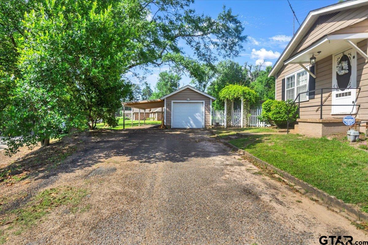 13926 State Highway 64 Tyler, TX 75707 - Photo 25 of 34 a front view of a house with a yard and garage