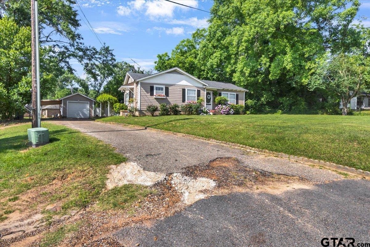 13926 State Highway 64 Tyler, TX 75707 - Photo 26 of 34 a front view of a house with a yard and trees