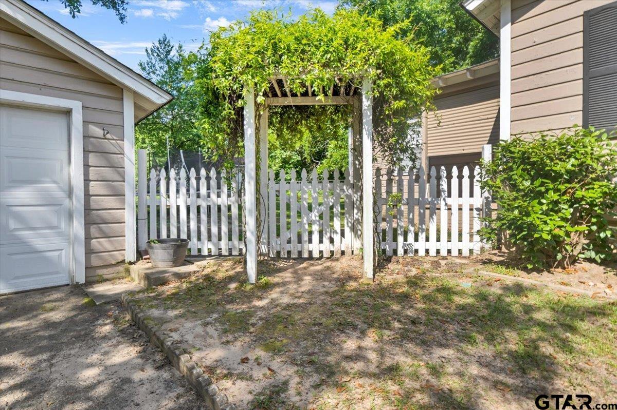 13926 State Highway 64 Tyler, TX 75707 - Photo 28 of 34 a view of a house with a small yard and wooden fence