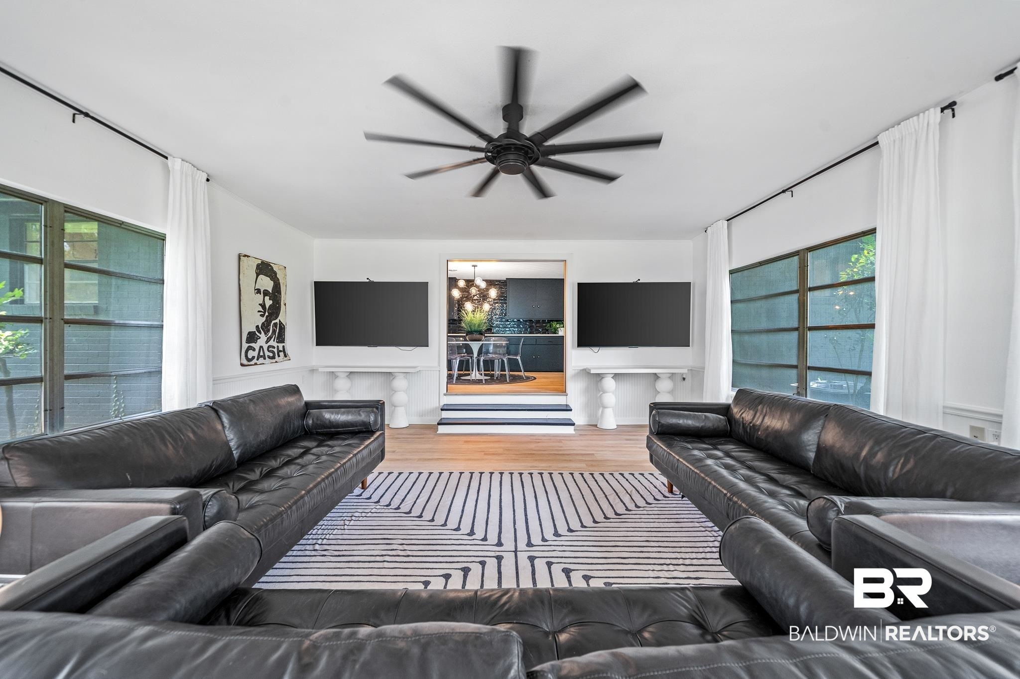 18513 Yacht Club Road Foley, AL 36535 - Photo 14 of 53 Living room featuring a wealth of natural light, wood-type flooring, and ceiling fan with notable chandelier
