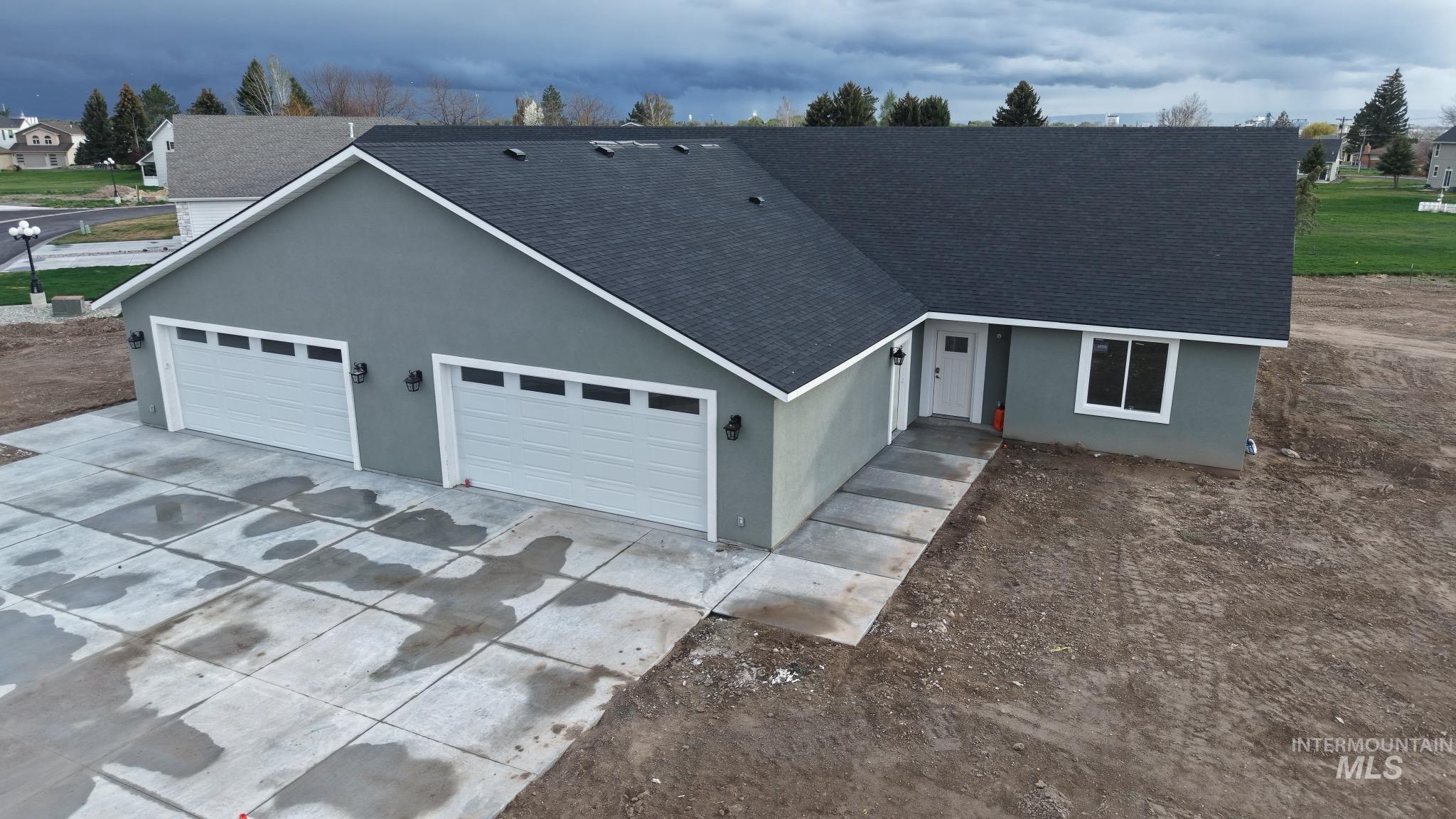 40 Lakeside Loop Burley, ID 83318 - Photo 14 of 15 Single story home featuring roof with shingles, concrete driveway, an attached garage, and stucco siding