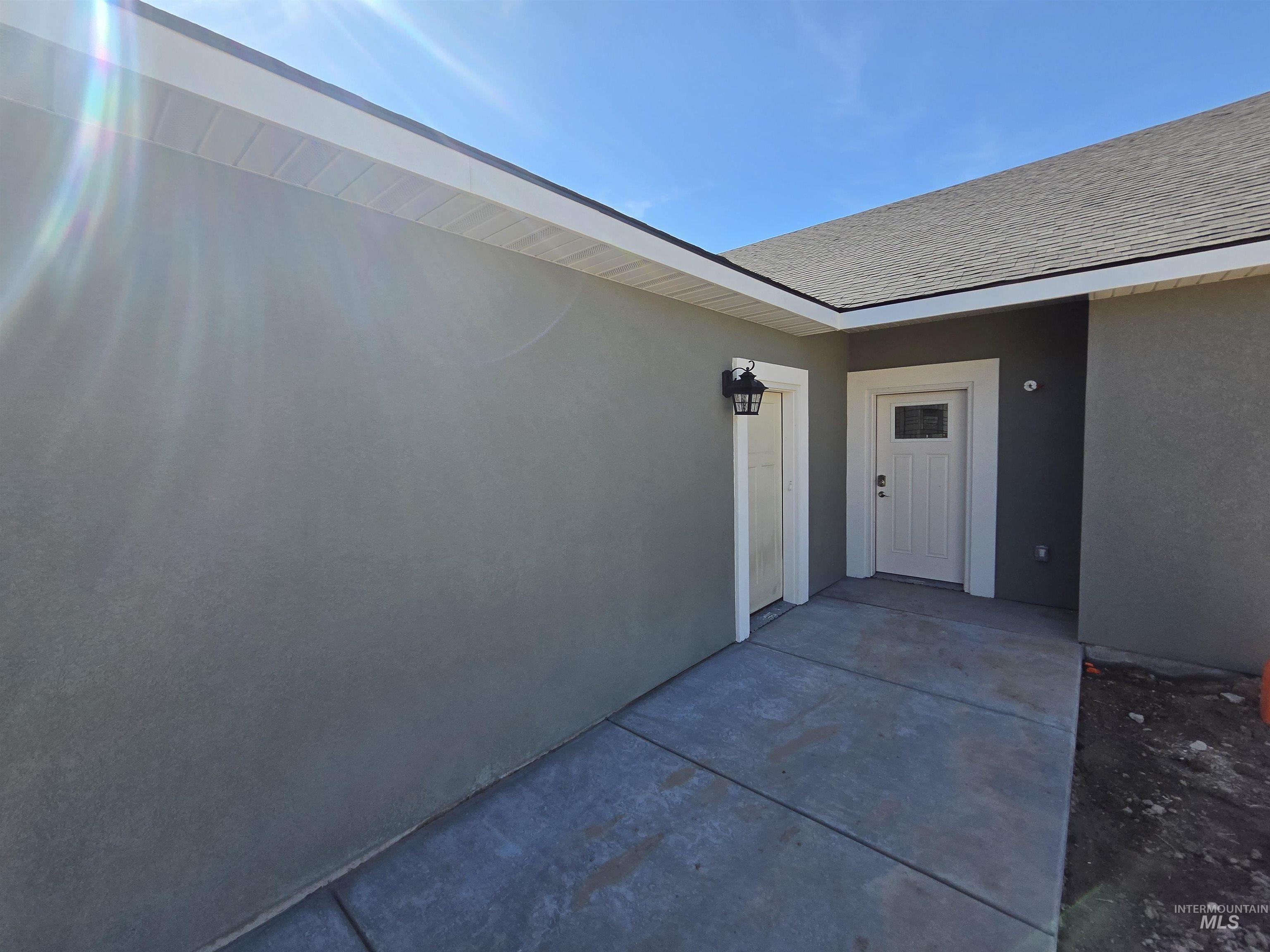 40 Lakeside Loop Burley, ID 83318 - Photo 2 of 15 Property entrance with stucco siding and roof with shingles