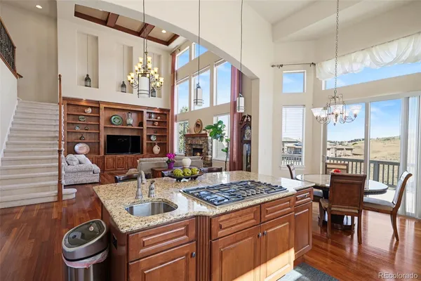 a bedroom with a bed chandelier and a window