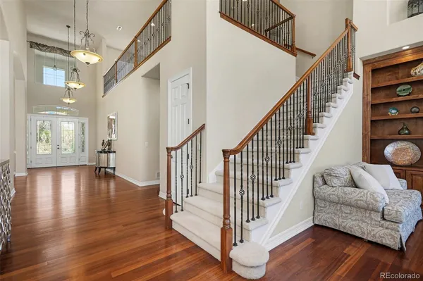a kitchen with granite countertop a sink appliances and wooden floor