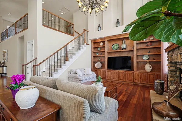 a living room with furniture a fireplace and a chandelier