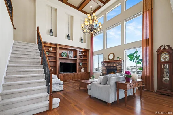 a living room with fireplace furniture and a wooden floor