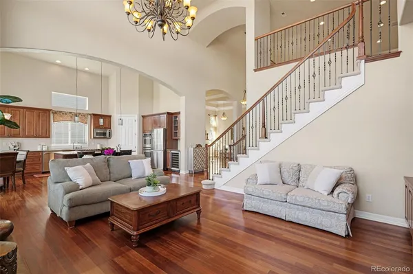 a kitchen with stainless steel appliances granite countertop a table chairs stove and refrigerator