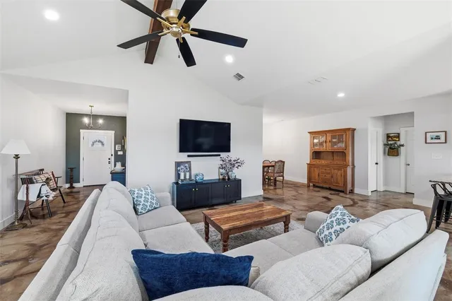 a living room with fireplace furniture and a flat screen tv