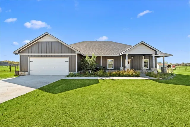 a front view of a house with a yard and porch