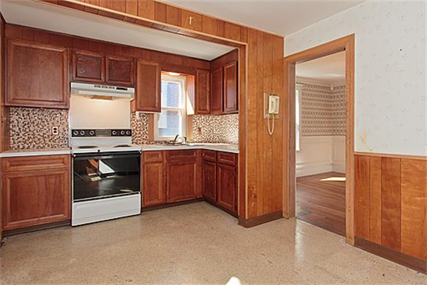 60 Robbins Road Arlington, MA 02476 - Photo 12 of 22 a kitchen with stainless steel appliances granite countertop a stove and a refrigerator
