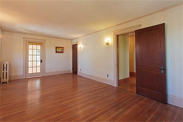 60 Robbins Road Arlington, MA 02476 - Photo 15 of 22 an empty room with wooden floor and windows with curtains