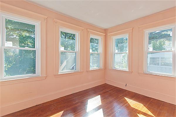 60 Robbins Road Arlington, MA 02476 - Photo 16 of 22 a view of an empty room with wooden floor and a window