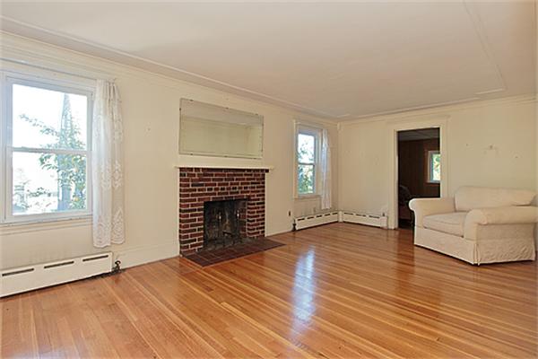 60 Robbins Road Arlington, MA 02476 - Photo 6 of 22 an empty room with fireplace wooden floor and windows
