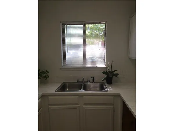 a bathroom with a sink and a window