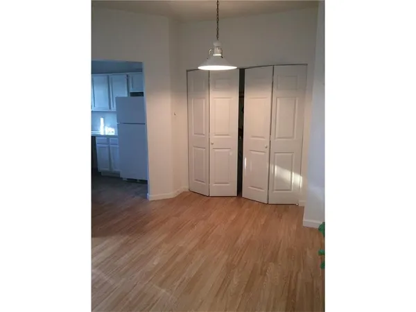 a view of a room with wooden floor and brick walls