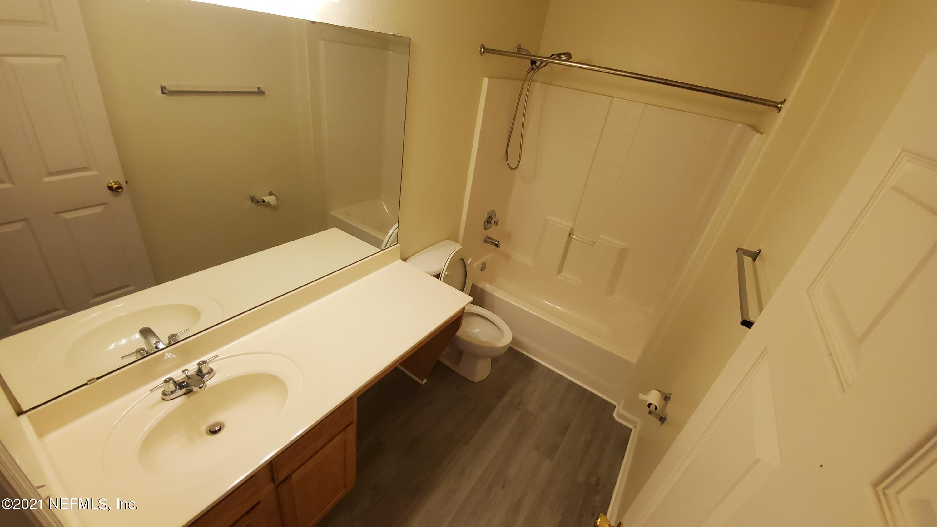 658 MacKenzie Circle St. Augustine, FL 32092 - Photo 12 of 13 a bathroom with a sink and a mirror