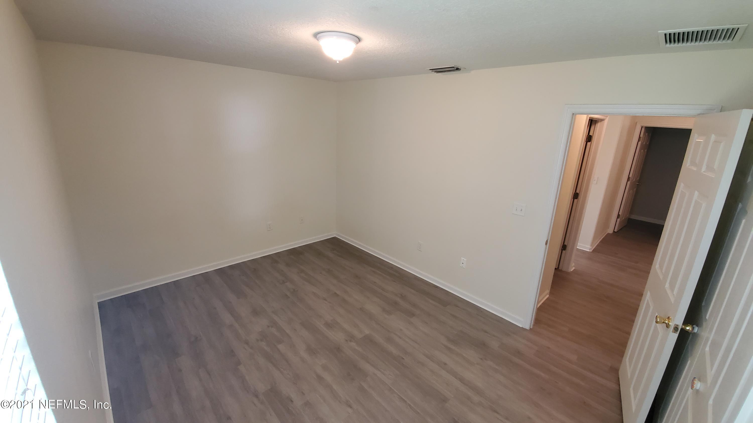 658 MacKenzie Circle St. Augustine, FL 32092 - Photo 13 of 13 an empty room with wooden floor and entrance