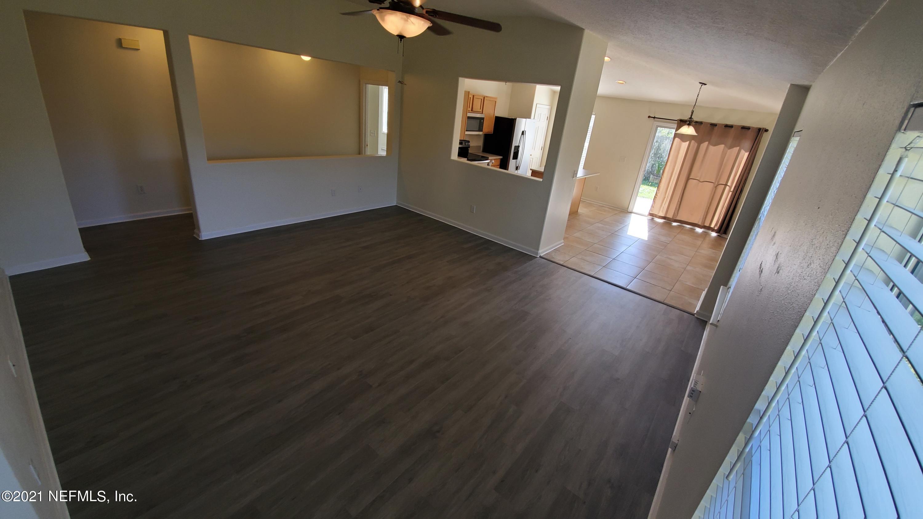 658 MacKenzie Circle St. Augustine, FL 32092 - Photo 4 of 13 a view of a hallway with wooden floor