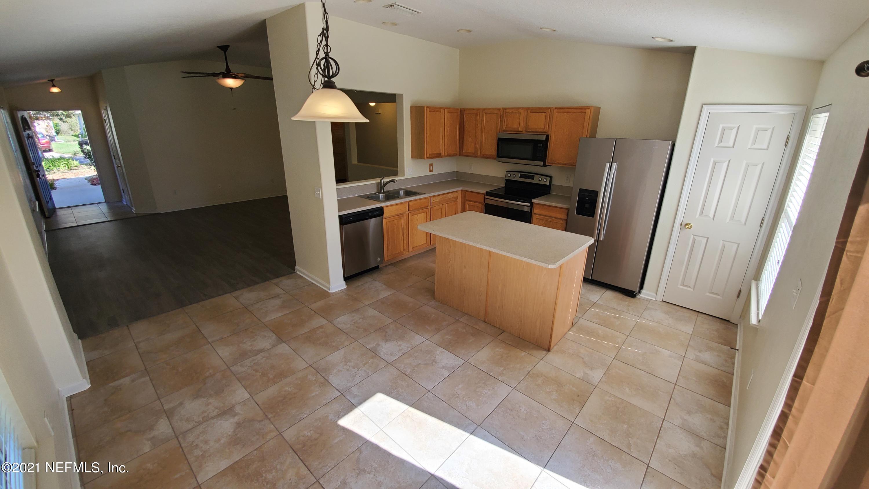 658 MacKenzie Circle St. Augustine, FL 32092 - Photo 6 of 13 a kitchen with refrigerator and window