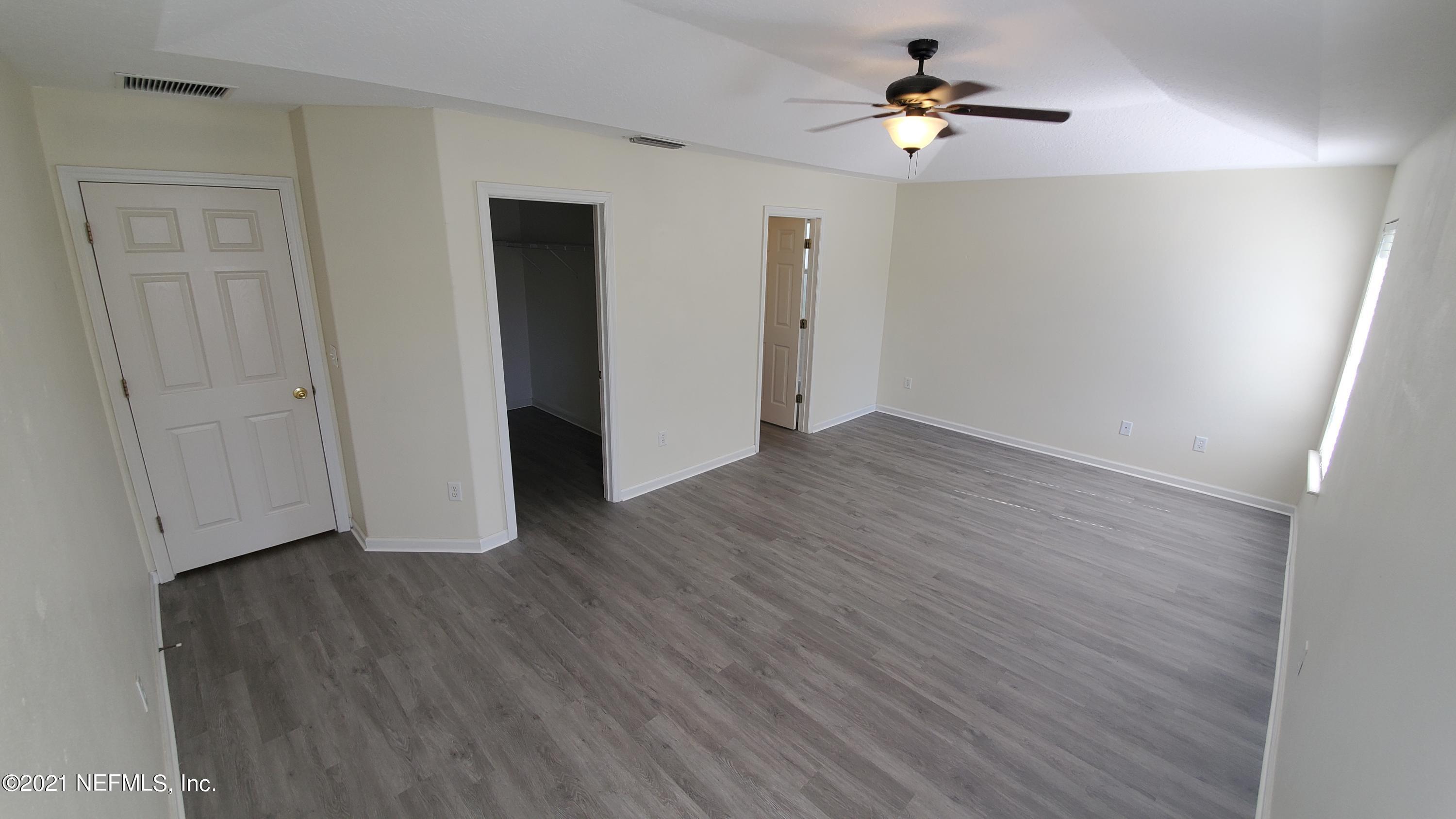 658 MacKenzie Circle St. Augustine, FL 32092 - Photo 9 of 13 wooden floor in an empty room with a window