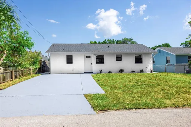 a front view of house with a garden