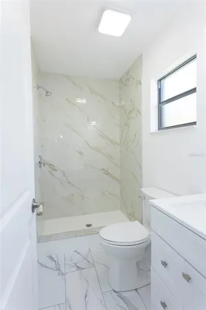 a bathroom with a toilet a sink and shower