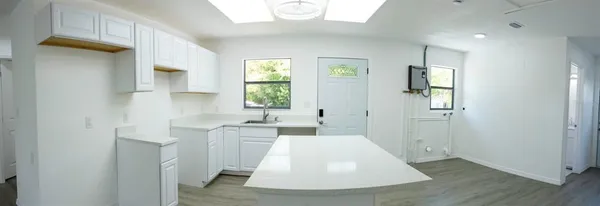 a view of a kitchen with a sink and a window