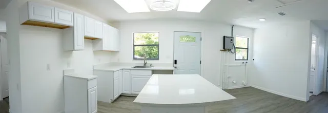 a view of a kitchen with a sink and a window