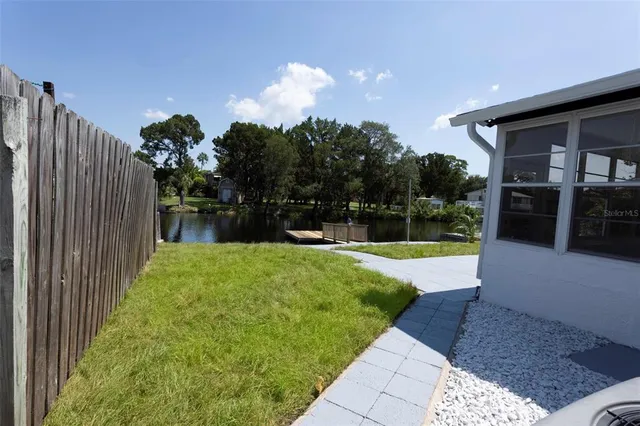 a view of a house with backyard and porch