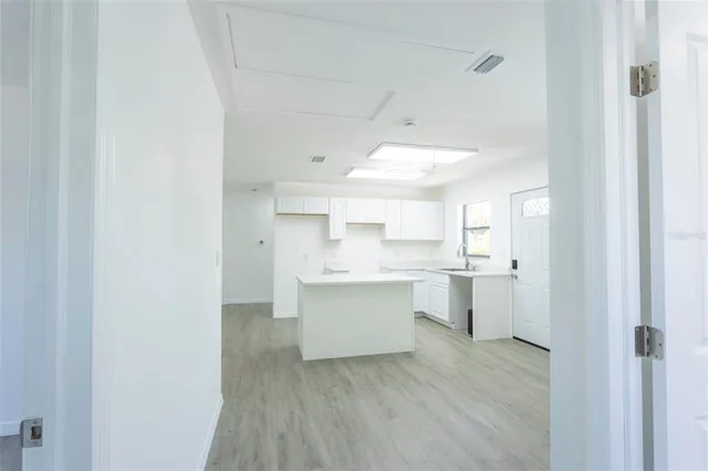 a room with white cabinets and sink