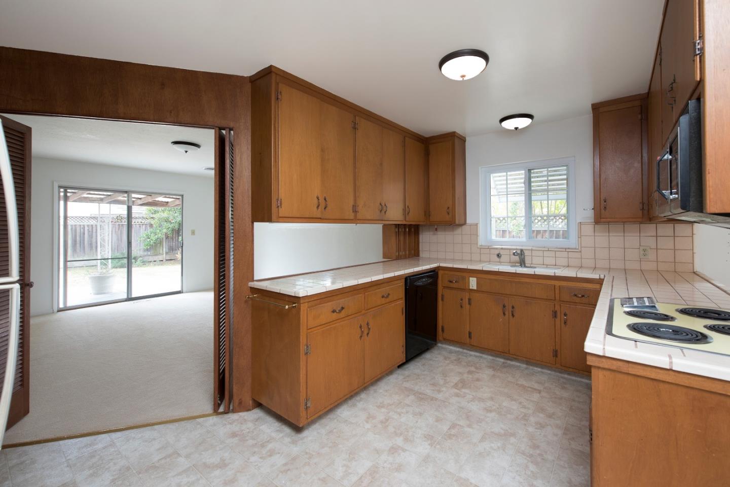 952 Covington Road Los Altos, CA 94024 - Photo 5 of 18 a kitchen with a refrigerator stove top oven and sink