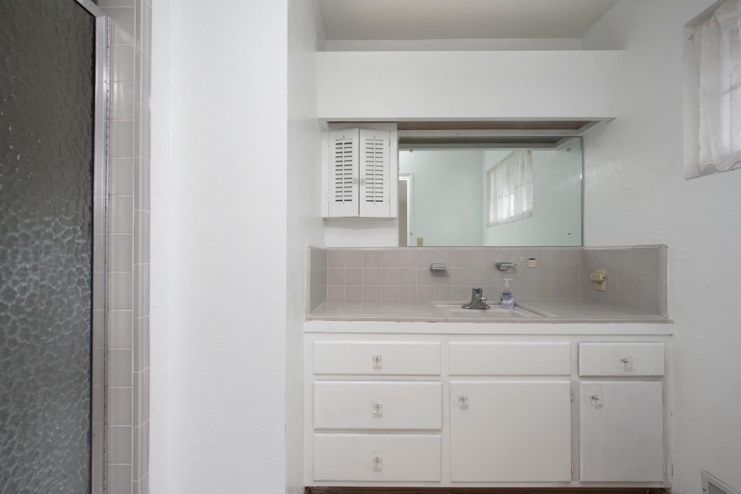 952 Covington Road Los Altos, CA 94024 - Photo 10 of 18 a bathroom with a sink and a mirror