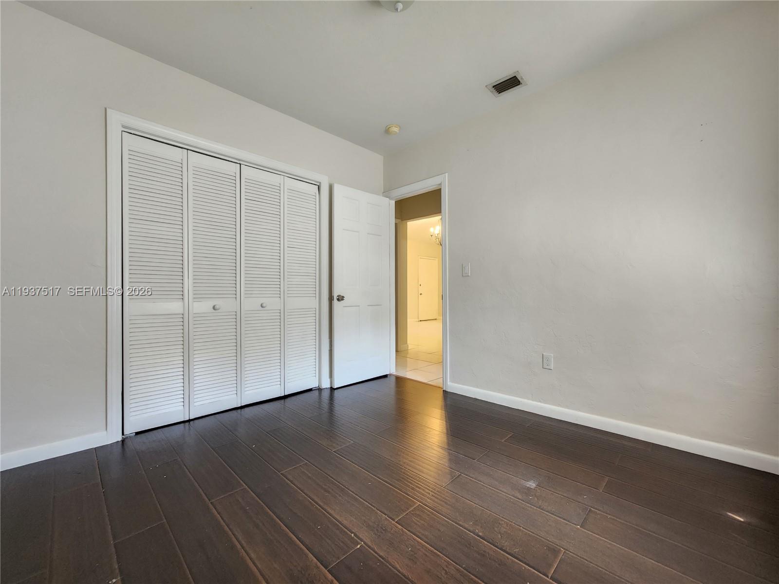 8335 Northeast 3rd Avenue, Unit 1 Miami, FL 33138 - Photo 12 of 12 a view of an empty room with wooden floor