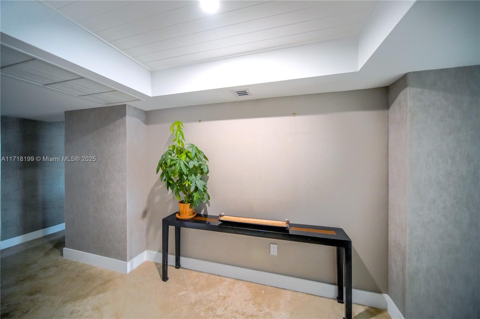 765 Crandon Boulevard, Unit 510 Key Biscayne, FL 33149 - Photo 5 of 28 a living room with a potted plant on the wall