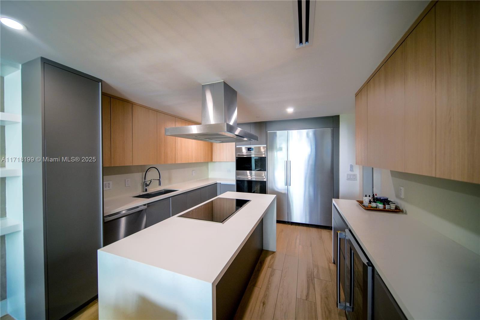 765 Crandon Boulevard, Unit 510 Key Biscayne, FL 33149 - Photo 6 of 28 a kitchen with a sink a counter top space stainless steel appliances and cabinets