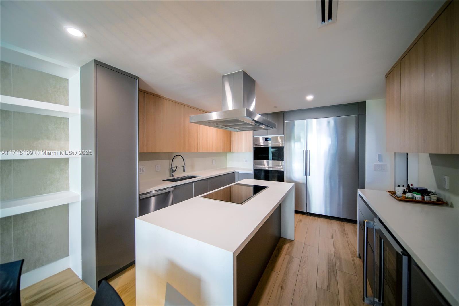 765 Crandon Boulevard, Unit 510 Key Biscayne, FL 33149 - Photo 8 of 28 a kitchen that has a lot of cabinets a sink and wooden floor