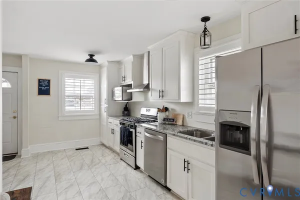 a kitchen with a stove a sink and a refrigerator