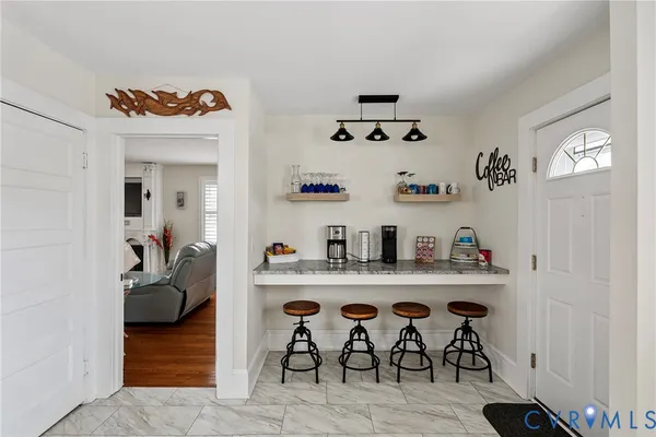 a view of a dining room with furniture and chandelier