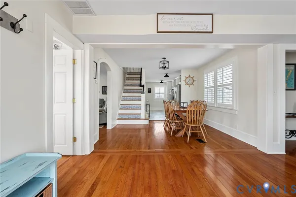 a dining room with furniture and wooden floor