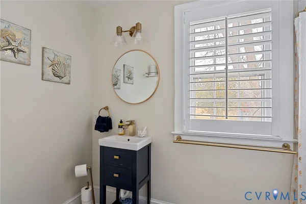 a bathroom with a sink a mirror and a window