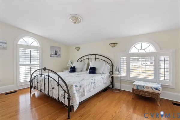 a bedroom with a bed next to a window with outer view