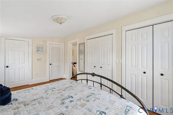 a big room with wooden floor and a chandelier fan