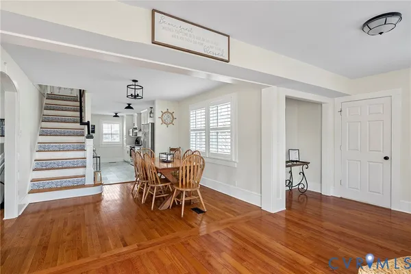 a dining room with furniture and wooden floor