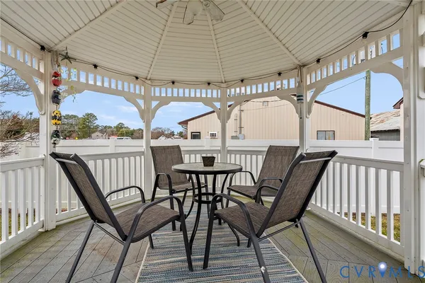 a view of a chairs and table in the balcony