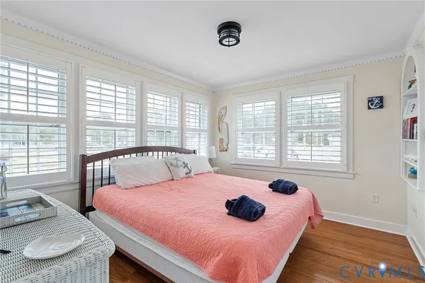 a bedroom with a bed and a large window