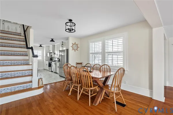 a view of a dining room with furniture window and wooden floor