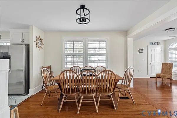 a view of a dining room with furniture window and wooden floor