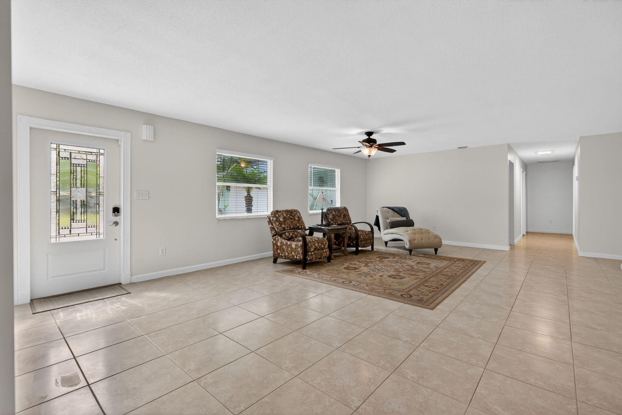 17391 Alexander Run Jupiter, FL 33478 - Photo 4 of 55 a living room with furniture and a chandelier
