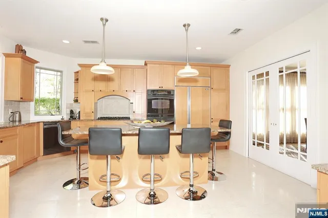 a living room with lots of furniture and view of kitchen